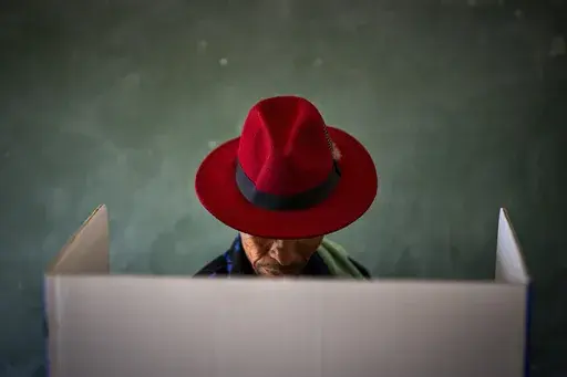 A voter fills out a ballot paper during general elections in Nkandla, Kwazulu Natal, South Africa, on May 29, 2024. (AP Photo/Emilio Morenatti, file)