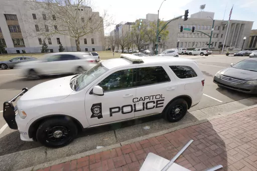 A Capitol Police SUV is parked across the street from the Hinds County Courthouse, left, and the main offices of the Jackson, Miss., Police Department, right, in downtown Jackson, Miss., Feb. 13, 2023. On Wednesday, Dec. 20, a woman who was shot in the head while she was a passenger in a car fleeing from police filed a federal lawsuit against the Mississippi Department of Public Safety, which oversees the Capitol Police, claiming excessive force. (AP Photo/Rogelio V. Solis, File)