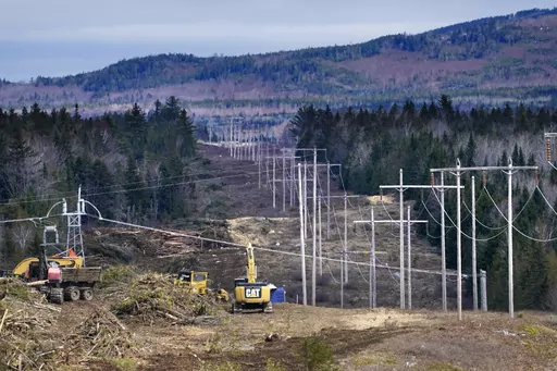 Heavy machinery is used to cut trees to widen an existing Central Maine Power power line corridor to make way for new utility poles, April 26, 2021, near Bingham, Maine. Stalled spending on electrical grids worldwide is slowing the rollout of renewable energy and could put efforts to limit climate change at risk if millions of miles of power lines aren't added or refurbished in the next few years. The International Energy Agency said in a report Tuesday that the capacity to connect to and transm