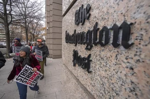Employees of the Washington Post picket outside the company's offices in downtown Washington, Thursday, Dec. 7, 2023, amid a one-day strike over labor issues. The Washington Post is completing buyouts to more than 200 staffers. (AP Photo/Mark Schiefelbein, File)