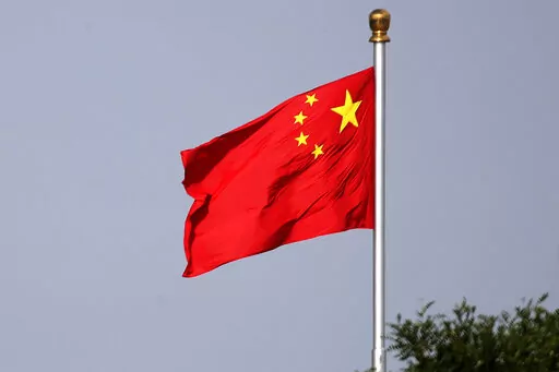 A Chinese national flag flies at Tiananmen Square in Beijing Thursday, June 14, 2018. A court in northern China sentenced one man to 24 years in jail Friday, Sept. 23, 2022, for his role in a vicious attack on four women, as well as other crimes including robbery and opening an illegal gambling ring. (AP Photo/Andy Wong, File)