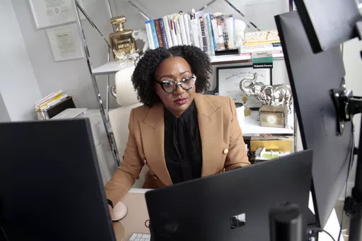 Chantel Adams, a senior marketing executive, sits in her home office Thursday, March 7, 2024, in Durham, N.C. Adams says she isn’t surprised that the gender pay gap persists even among men and women with the same level and quality of education, or that the gap is wider for Black and Hispanic women. (AP Photo/Chris Seward)