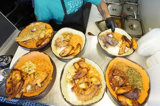 A sampling of East African cuisine is prepared at the Baobab Fare restaurant, Friday, May 24, 2024, in Detroit. For Hamissi Mamba and Nadia Nijimbere _ who own Baobab Fare in Detroit _ a win among the five finalists in the James Beard's "Outstanding Restaurateur" category would be personal. The couple, who fled Burundi about a decade ago, faced a difficult road as refugees opening a business in America. (AP Photo/Carlos Osorio)