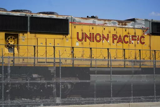 A Union Pacific train engine sits in a rail yard on Wednesday, Sept. 14, 2022, in Commerce, Calif. Union Pacific said Saturday, March 25, 2023, that the company has backed away from the industry's longstanding push to cut train crews down to one person as lawmakers and regulators increasingly focus on rail safety following last month's fiery derailment in Ohio. (AP Photo/Ashley Landis, File)