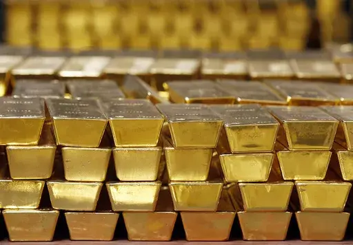 Gold bars are shown stacked in a vault at the United States Mint, on July 22, 2014, in West Point, N.Y. (AP Photo/Mike Groll, File)