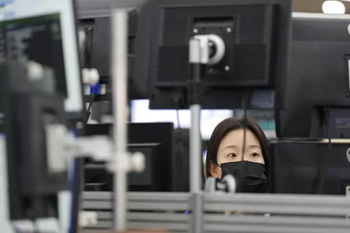 A currency trader watches computer monitors at a foreign exchange dealing room in Seoul, South Korea, Tuesday, Oct. 25, 2022. Shares advanced Tuesday in Asia after Wall Street shook off an early bout of unsettled trading and ended higher. (AP Photo/Lee Jin-man)