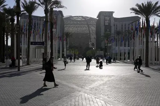 People walk through the venue at the COP28 U.N. Climate Summit near the Al Wasl Dome at Expo City, Thursday, Nov. 30, 2023, in Dubai, United Arab Emirates. (AP Photo/Rafiq Maqbool, File)