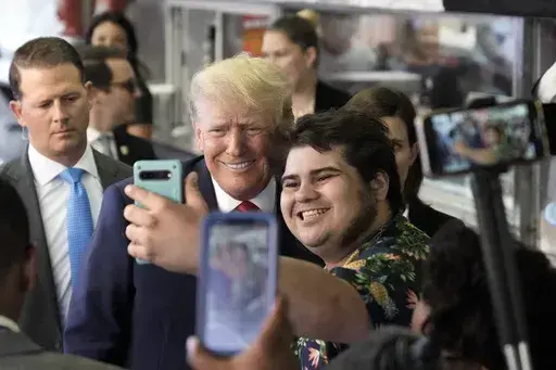Former President Donald Trump poses for a photo as he visits Pat's King of Steaks in Philadelphia, Friday, June 30, 2023. (AP Photo/Matt Rourke)