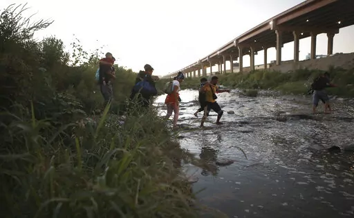 Venezuelan migrants walk across the Rio Bravo towards the United States border to surrender to the border patrol, from Ciudad Juarez, Mexico, Oct. 13, 2022. A surge in migration from Venezuela, Cuba and Nicaragua in September brought the number of illegal crossings to the highest level ever recorded in a fiscal year, according to U.S. Customs and Border Protection. (AP Photo/Christian Chavez, File)