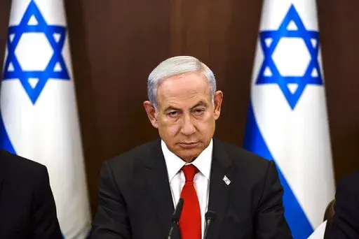 Israeli Prime Minister Benjamin Netanyahu convenes a weekly cabinet meeting at the Prime Minister's office in Jerusalem, Sunday, Jan. 8, 2023. (Ronen Zvulun/Pool Photo via AP)