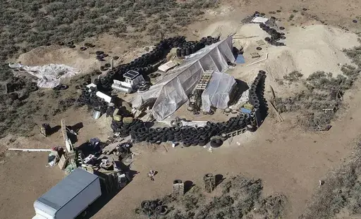 A ramshackle compound is seen in the desert area of Amalia, N.M., on Aug. 10, 2018. A U.S. judge is expected to hand down sentences Wednesday, March 6, 2024, for five defendants in a federal terrorism and kidnapping case that stemmed from the search for a toddler who went missing from Georgia in late 2017 that ended months later with a raid on the squalid compound in northern New Mexico. (AP Photo/Brian Skoloff, File)