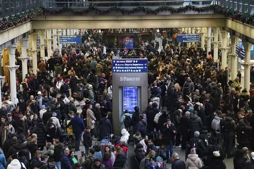 Passengers wait on the concourse at the entrance to the Eurostar in St Pancras International station, central London, Saturday Dec. 30, 2023, after high-speed services between London and Ebbsfleet were cancelled because of flooding in a tunnel under the Thames. (James Manning/PA via AP)