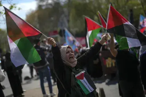 A woman waves flags in support of Palestinians in Gaza during a protest in Istanbul, Turkey, Friday, April 5, 2024. Turkey and Israel announced tit-for-tat trade barriers on Tuesday, April 9, 2024, as relations between them further deteriorated amid the war in Gaza. Turkey, a staunch critic of Israel’s military actions in Gaza, first announced that it was restricting exports of 54 types of products to Israel with immediate effect. The products include aluminum, steel, construction products, je