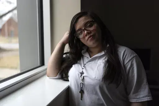 31-year-old Crystal Martinez stands for a portrait after speaking about her experiences with domestic violence and life in prison without her children Friday, Jan. 26, 2024, at Logan Correctional Center in Lincoln, Ill. Martinez's eight-year sentence for shooting a man she said was beating his girlfriend at the time was recently reduced under an Illinois law that allows survivors of domestic violence to ask for shorter sentences. (AP Photo/Erin Hooley)