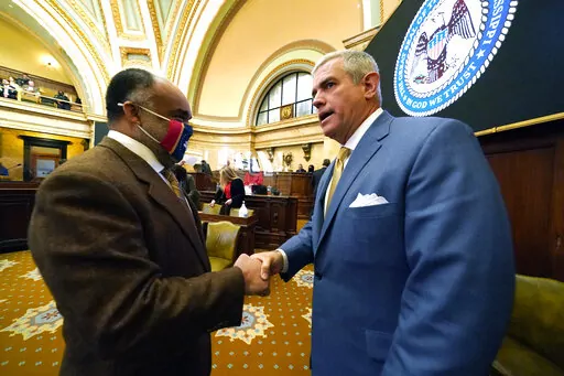 House Speaker Philip Gunn, R-Clinton, right, greets Rep. Charles Young, D-Meridian, prior to the start of the 90-day session at the Mississippi State Capitol in Jackson, Miss., Tuesday, Jan. 4, 2022. Gunn is pushing a plan to eliminate the state income tax over several years. (AP Photo/Rogelio V. Solis, File)