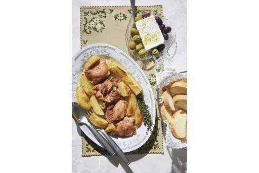 This image released by Harvest shows a recipe for Greek chicken from "The League of Kitchens Cookbook: Brilliant Tips, Secret Methods & Favorite Family Recipes from Around the World" by Lisa Kyung Gross. (Kristin Teig/Harvest via AP)