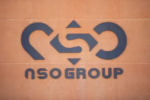 A logo adorns a wall on a branch of the Israeli NSO Group company, near the southern Israeli town of Sapir, Tuesday, Aug. 24, 2021. A new report says Israeli-made Pegasus spyware was used in Jordan to hack the cellphones of nearly three dozen people including journalists, lawyers and human rights activists. The digital rights group Access Now said the hacking with spyware made by the NSO Group occurred from early 2020 until November. (AP Photo/Sebastian Scheiner, File)