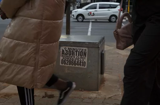 Women pass a sticker advertising abortion pills on a sidewalk in Johannesburg, Wednesday June 28, 2023. When the U.S. Supreme Court overturned the national right to an abortion a year ago, it shook efforts to legalize and make abortions safer in Africa. Sub-Saharan Africa has the world's highest rate of unintended pregnancies, and 77% of abortions are estimated to be unsafe. (AP Photo/Denis Farrell)