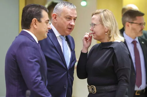 From left, Greek Energy Minister Kostas Skrekas and Czech Energy Minister Jozef Sikela speak with Polish Minister of Climate and Environment Anna Moskwa prior to a meeting of EU energy ministers at an extraordinary energy council in Brussels, Thursday, Nov. 24, 2022. (AP Photo/Olivier Matthys)