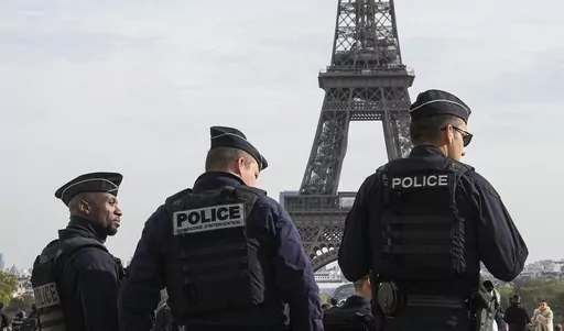 Police officers patrol the Trocadero plaza near the Eiffel Tower in Paris, Tuesday, Oct. 17, 2023. Police have arrested a man climbing on the Eiffel Tower. The drama temporarily stranded a crowd at the top. Among those trapped was a Washington, D.C., couple who decided during the wait to get married and an Associated Press reporter who got their story. Amir Khan had been planning to propose to Kate Warren later Thursday in a Paris garden away from the crowds, with a romantic dinner on the River 