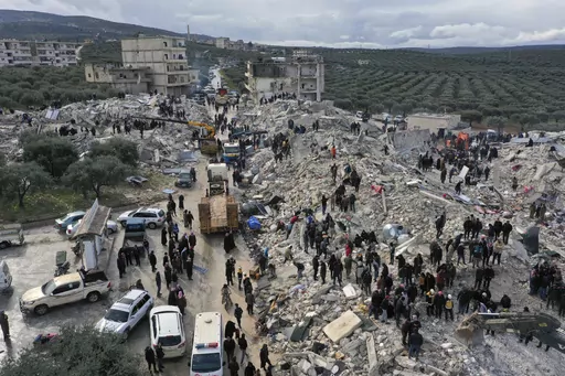 Civil defense workers and residents search through the rubble of collapsed buildings in the town of Harem near the Turkish border, Idlib province, Syria, Monday, Feb. 6, 2023. (AP Photo/Ghaith Alsayed, File)