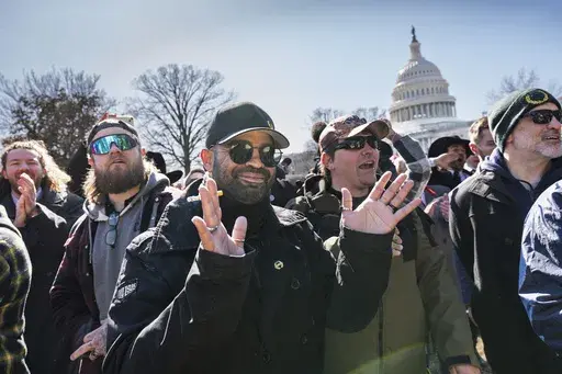 Former Proud Boys leader Enrique Tarrio, center, speaks outside the U.S. Capitol in Washington, Friday, Feb. 21, 2025. (AP Photo/J. Scott Applewhite)