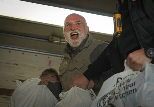 Jose Andres, a Spanish chef, and founder of World Central Kitchen unloads the humanitarian food packages delivered with WCK's truck in Kherson, Ukraine, on Nov. 15, 2022. World Central Kitchen, called a halt to its work in the Gaza Strip after an apparent Israeli strike killed seven of its workers, mostly foreigners. (AP Photo/Efrem Lukatsky, File)