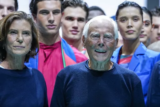 Silvana Armani, left, and Giorgio Armani stand with models after the Emporio Armani Spring Summer 2022 collection during Milan Fashion Week, in Milan, Italy, Thursday, Sept. 23, 2021. Giorgio Armani said Tuesday, Jan. 4, 2022 he was cancelling his men’s fashion show in Milan this month and his Prive haute couture show in Paris because of soaring coronavirus cases in Europe. (AP Photo/Luca Bruno, File)