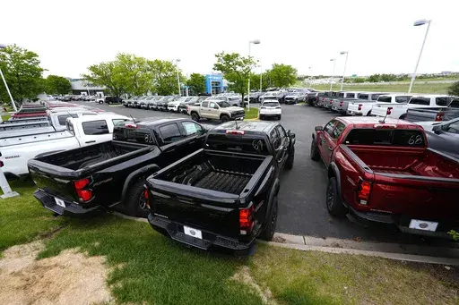 Unsold 2024 Colorado and Silverado pickup trucks sit in rows outside a Chevrolet dealership Sunday, June 2, 2024, in Lone Tree, Colo. (AP Photo/David Zalubowski,File)
