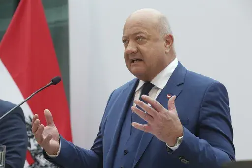Austrian party leader Christian Stocker of the Peoples' Party (OeVP) addresses a news conference after agreeing to form a coalition government with the Social Democrats (SPOe) and NEOS in Vienna, Austria, Thursday, Feb 27, 2025. (AP Photo/Heinz-Peter Bader)