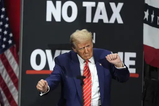 Republican presidential nominee former President Donald Trump dances at a campaign event at the Cobb Energy Performing Arts Centre, Oct. 15, 2024, in Atlanta. (AP Photo/John Bazemore, file)