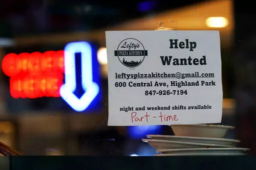 Hiring sign is displayed at a restaurant in Highland Park, Ill., Thursday, July 14, 2022.  The nation's job market last month delivered just what the Federal Reserve and nervous investors had hoped for: A Goldilocks-style hiring report. Job growth was solid — not too hot, not too cold. And more Americans began looking for work, which could ease worker shortages over time and defuse some of the inflationary pressures that the Fed has made its No. 1 mission. (AP Photo/Nam Y. Huh)