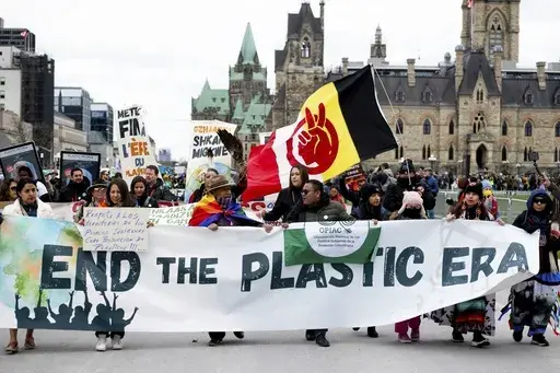 People participate in a March to End the Plastic Era on Parliament Hill in Ottawa, Ontario, on April 21, 2024. (Spencer Colby/The Canadian Press via AP, File)