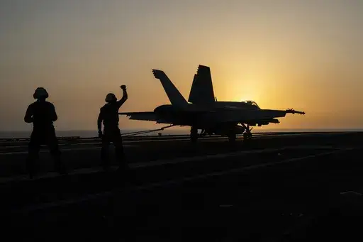 A fighter jet lands on the USS Dwight D. Eisenhower, also known as "IKE," in the Red Sea on Tuesday, June 11, 2024. The U.S.-led campaign against Iran-backed Houthi rebels has turned into the most intense running sea battle the Navy has faced since World War II. That's what its leaders and experts tell The Associated Press, whose journalists visited U.S. ships off Yemen in recent days. (AP Photo/Bernat Armangue)