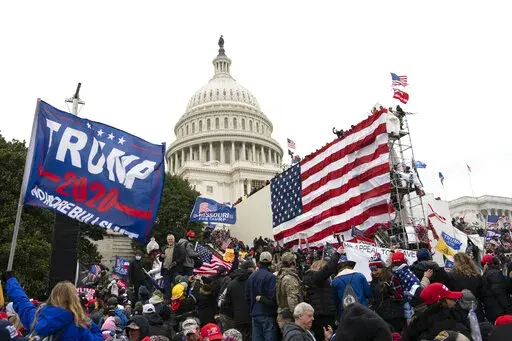 Violent insurrectionists loyal to President Donald Trump stand outside the U.S. Capitol in Washington on Jan. 6, 2021. The public hearings of the House committee investigating the insurrection pose a challenge to Democrats seeking to maintain narrow control of Congress. (AP Photo/Jose Luis Magana, File)