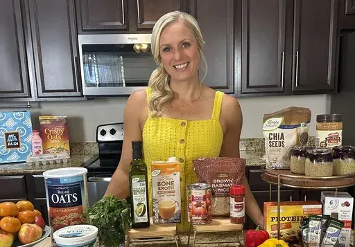 Jenna Braddock, co-author of "The High-Protein Vegan Cookbook for Athletes: 70 Whole-Foods Recipes to Fuel Your Body," poses in her kitchen on Aug. 17, 2024 in St, Augustine, Fla. (Jenna Braddock via AP)