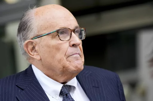 Rudy Giuliani speaks with reporters as he departs the federal courthouse, May 19, 2023, in Washington. Giuliani is not disputing that he publicly made statements about two Georgia election workers that were defamatory and false, but he contends they were constitutionally protected statements, according to a statement filed in court. (AP Photo/Patrick Semansky, File)