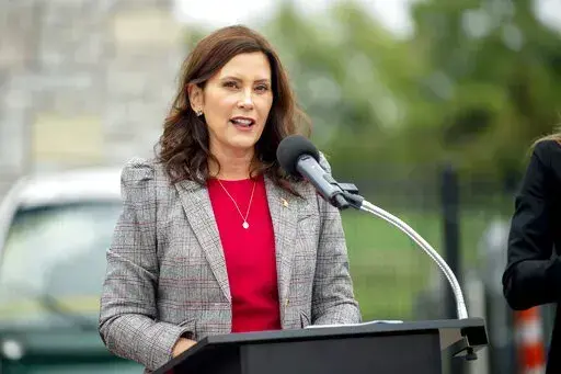 Michigan Gov. Gretchen Whitmer announces the first round of Michigan Mobility Funding Platform grants on Sept. 15, 2021, at the GM Mobility Research Center at Kettering University in Flint, Mich. The plot to kidnap Whitmer represents a growing anger in U.S. politics, and violence – both physical and non-physical – that is disproportionately aimed at women elected officials and candidates, and particularly women of color. (Jake May/The Flint Journal via AP, File)