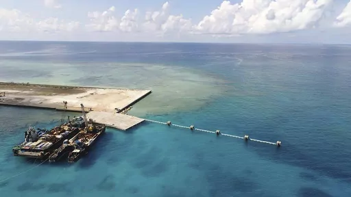 In this photo provided by the Department of National Defense PAS, ships carrying construction materials are docked at the newly built beach ramp at the Philippine-claimed island of Pag-asa, also known as Thitu, in the disputed South China Sea on June 9, 2020. The Philippine coast guard inaugurated a new monitoring base Friday, Dec. 1, 2023, on a remote island occupied by Filipino forces in the disputed South China Sea as Manila ramps up efforts to counter China’s increasingly aggressive action