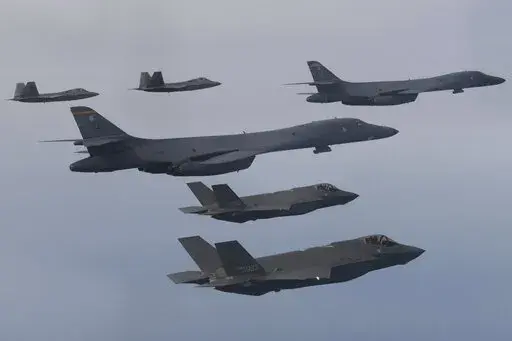 In this photo provided by South Korean Defense Ministry, U.S. Air Force B-1B bombers, center, F-22 fighter jets and South Korean Air Force F-35 fighter jets, bottom, fly over South Korea Peninsula during a joint air drill in South Korea, on Jan. 1, 2023. South Korean and U.S. militaries will hold a table-top exercise at the Pentagon next week to hone their joint response to a potential use of nuclear weapons by North Korea, Seoul officials said Friday, Feb. 17, 2023. (South Korean Defense Minist