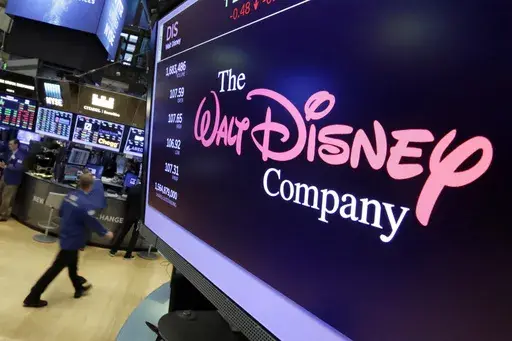 In this Aug. 8, 2017, file photo, The Walt Disney Co. logo appears on a screen above the floor of the New York Stock Exchange. (AP Photo/Richard Drew, File)
