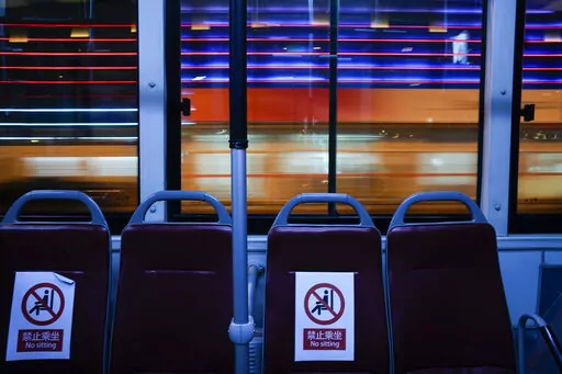 An Olympic shuttle bus passes the National Indoor Stadium, a venue for hockey events, at the 2022 Winter Olympics, Thursday, Feb. 10, 2022, in Beijing. (AP Photo/Jae C. Hong)