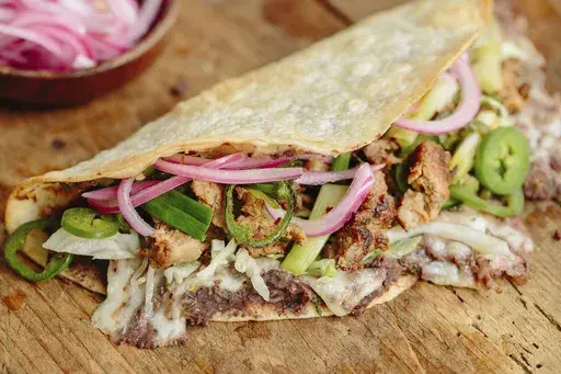 This image released by Milk Street shows a recipe for tlayudas. (Milk Street via AP)