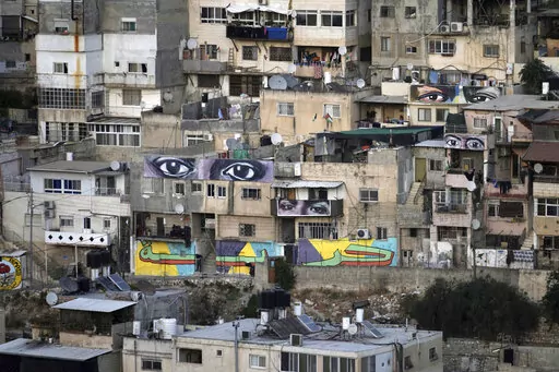 Murals that are part of the public art project 'I Witness Silwan' depicting the eyes of local and international figures, including George Floyd, a Black American killed by police, top right, in the Silwan neighbourhood of east Jerusalem, Friday, Aug. 26, 2022. Eyes are always open in this flashpoint district. Now, new eyes emerged; they were painted on the walls of the decaying Palestinian homes. The eye murals, and graffiti of Palestinian symbols, are so giant that make you feel they are watchi
