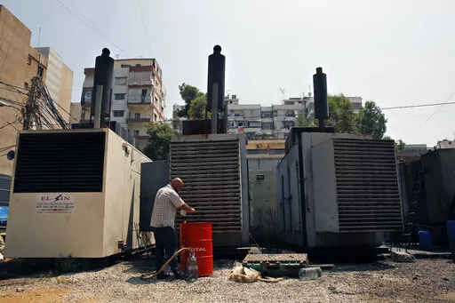 Mamdouh al-Amari refuels privately-owned diesel generators that provide power to homes and businesses, in the southern suburbs of Beirut, Lebanon, July 16, 2018. Internet services were disrupted in Lebanon Sunday, Jan. 16, 2022, because of diesel shortages, according to the state provider, adding another essential service to the list of casualties of the country’s snowballing economic crisis. (AP Photo/Bilal Hussein, File)