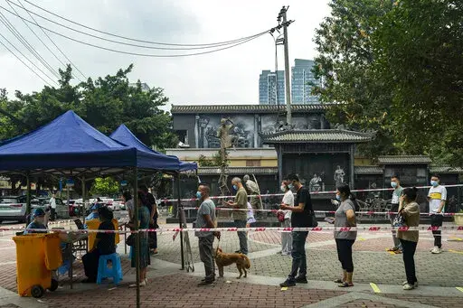 Residents line up for Covid-19 screening in Chengdu in southwestern China's Sichuan province Tuesday, Aug. 30, 2022. Chinese authorities have locked down Chengdu, a southwestern city of 21 million people, following a spike in COVID-19 cases. (Chinatopix Via AP)