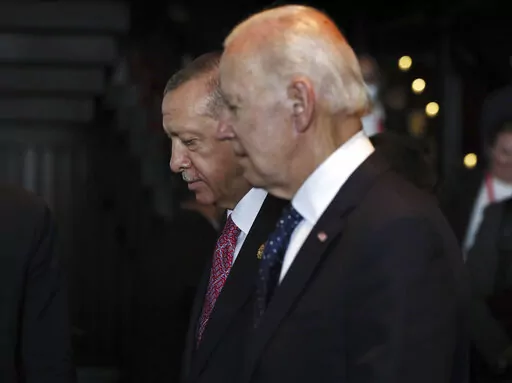 Turkish President Recep Tayyip Erdogan, left, walks with U.S. President Joe Biden during the G20 leaders' summit in Nusa Dua, Bali, Indonesia, Nov. 15, 2022. Biden administration officials are toughening their language toward NATO ally Turkey as they try to talk Turkish President Recep Erdogan out of launching a bloody and destabilizing ground offensive against American-allied Kurdish forces in neighboring Syria. (Made Nagi/Pool Photo via AP)