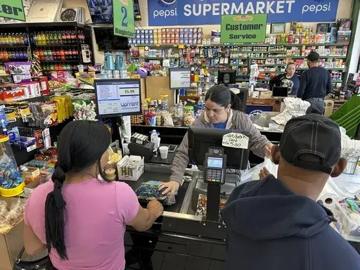Cashier Rosa Dilone helps customers at Mi Tierra Supermarket in Hazleton, Pa., on May 16, 2024. (AP Photo/Mark Scolforo, File)