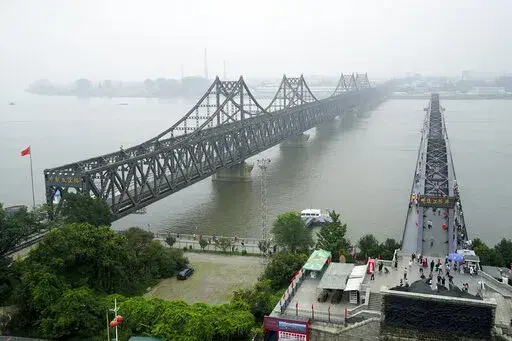 Visitors walk across the Yalu River Broken Bridge, right, next to the Friendship Bridge connecting China and North Korea in Dandong in northeastern China's Liaoning province, Sept. 9, 2017. After spending two years in a strict lockdown because of the COVID-19 pandemic, North Korea may finally be opening up — slowly. The reason could reflect a growing sense of recognition by the leadership that the nation badly needs to win outside economic relief. (AP Photo/Emily Wang, File)