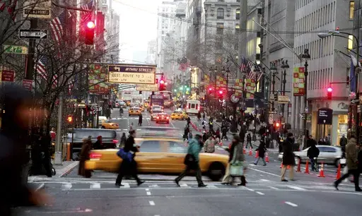 Vehicles and pedestrians make their way down Fifth Avenue in New York, Dec. 22, 2005, . (AP Photo/Diane Bondareff, File)